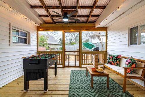 a screened porch with a ping pong table and a ceiling at Raleigh's Most Wanted - Relax, Games, & Cozy Comfort in Raleigh