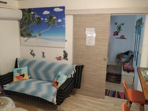 a living room with a couch in the corner at Charmant appart in Fort-de-France