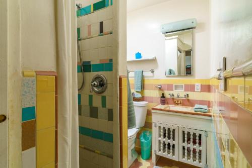 a bathroom with a toilet and a sink at Cactus Adobe in Twentynine Palms