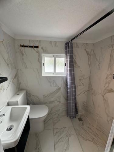 a bathroom with a toilet and a sink at Cascais Garden House 102 in Cascais