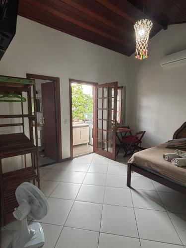a bedroom with a bed and a room with a table at Bora Bora Geribá Kitnet in Búzios