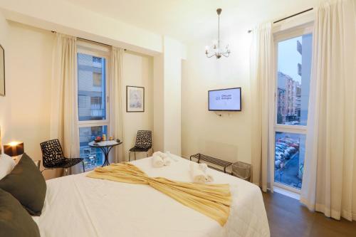 a bedroom with a white bed and a window at G House in Bologna