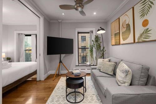 a living room with a couch and a bed at Sleek Lower East Side Retreat in New York