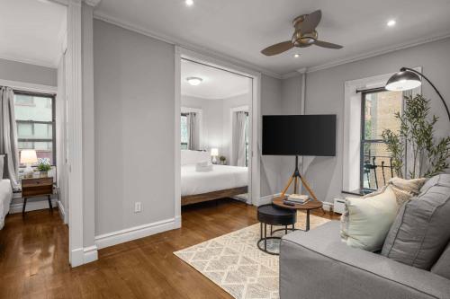 a living room with a couch and a bed at Sleek Lower East Side Retreat in New York
