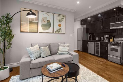 a living room with a couch and a table at Sleek Lower East Side Retreat in New York