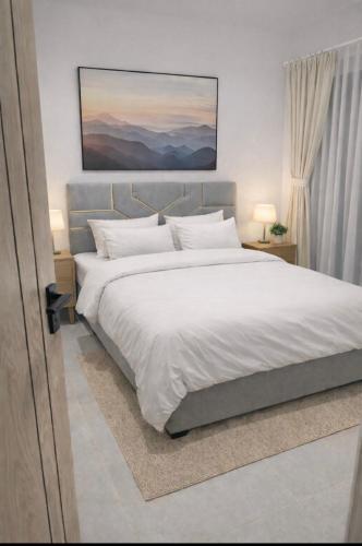 a bedroom with a large bed with white sheets at Casas Del Mar Cabo B8 in Martil