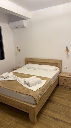 a bedroom with a large bed with towels on it at Morea Apartments in Ulcinj