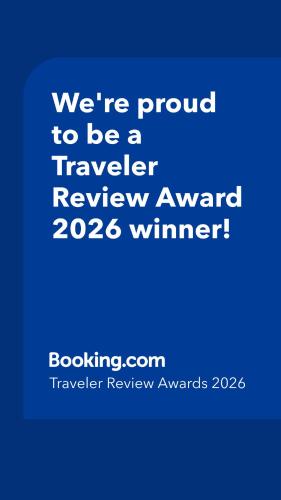 a blue sign that says were proud to be a traveler reviewagency winner at 2026 Award Winner, Luxe 2BR, steps to sand & pier, with fire pit, AC and parking in Newport Beach
