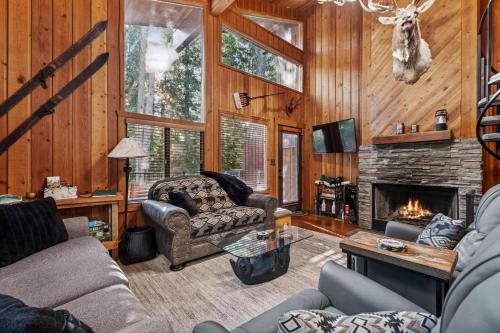a living room with a couch and a fireplace at Creekside Retreat in Whitefish