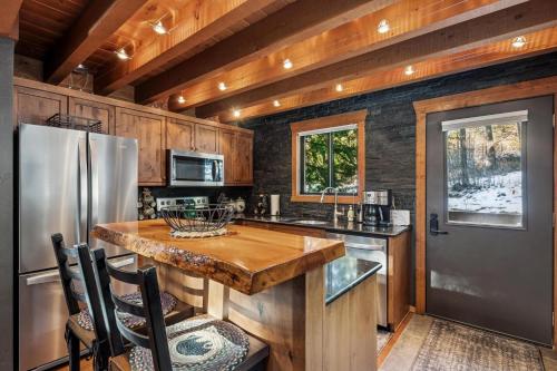 a kitchen with a wooden table and a refrigerator at Creekside Retreat in Whitefish