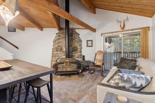 a living room with a stone fireplace and a couch at Nordic Nook in Whitefish