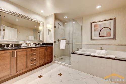 a bathroom with a tub and a shower and a sink at MGM Signature 34-818 Jacuzzi Studio Upper Penthouse in Las Vegas