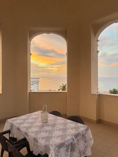 a dining room with a table and a view of the ocean at Villa Giada in Trani