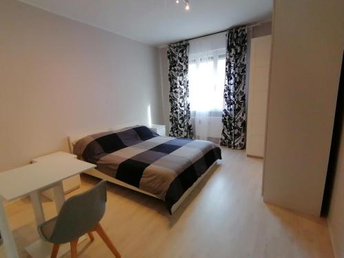 a bedroom with a bed and a desk and a chair at Frank's studio rooms in Padova