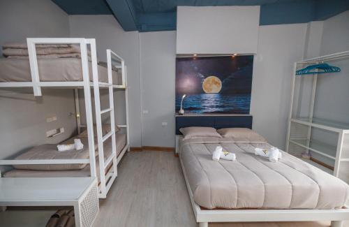 a bedroom with two bunk beds and a window at The Moon Hostel Huahin in Hua Hin