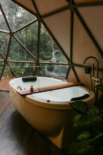 a bath tub in a room with a large window at Cabana winchesters - Domo in Cascavel