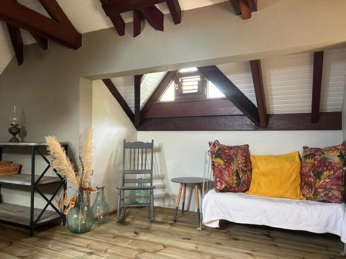 a living room with a couch and a chair at La Villa Terracotta - Vue mer panoramique in Le Diamant