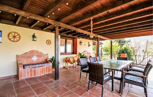 a patio with a table and chairs and a fireplace at Casa Rural Montion in Jimera de Líbar