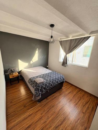 a bedroom with a bed and a window at Soul Home in Momoxpan