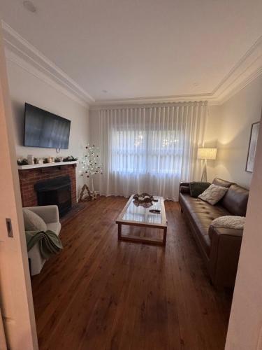 a living room with a couch and a coffee table at Ocean Breeze Cottage in Umina