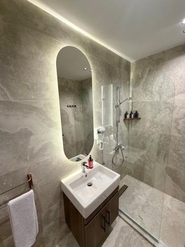 a bathroom with a sink and a shower and a mirror at Solima pyramids inn in Cairo