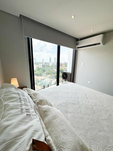 Tempat tidur dalam kamar di Edificio Garden Park