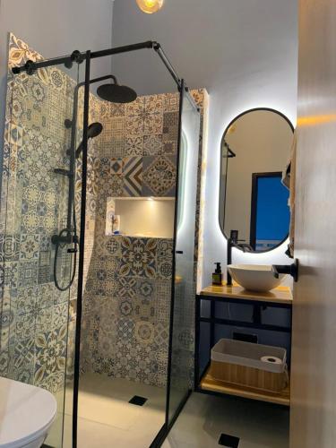 a bathroom with a shower and a sink and a mirror at Living Sincelejo in Sincelejo