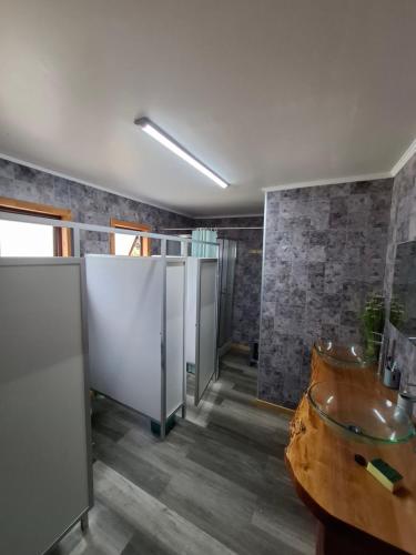 a bathroom with two urinals and two sinks in it at Habitación privada en Coñaripe de 1 Cama in Coñaripe