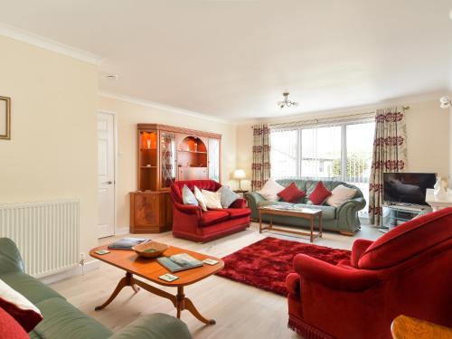 a living room with two couches and a table at Westburn in Comrie