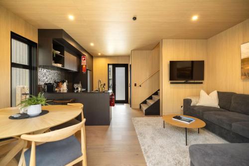 a living room with a couch and a table at Whetu Villa Queenstown in Queenstown