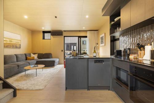a kitchen and living room with a couch at Whetu Villa Queenstown in Queenstown