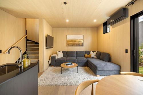 a living room with a couch and a table at Whetu Villa Queenstown in Queenstown