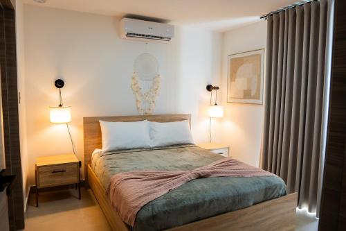 a bedroom with a bed with two lamps at Punta Cana with Private Jacuzzi in Punta Cana