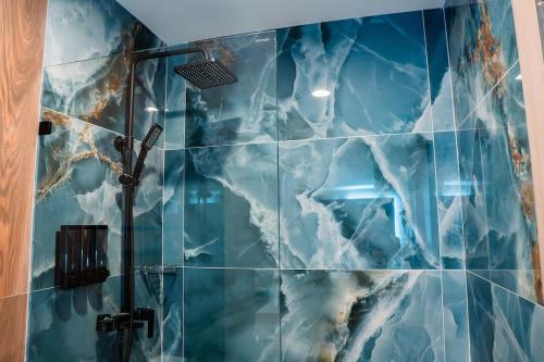 a bathroom with a shower with blue tiles at Punta Cana with Private Jacuzzi in Punta Cana