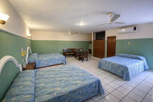 a hospital room with two beds and a table at Blue Pacific Suites in Mazatlán