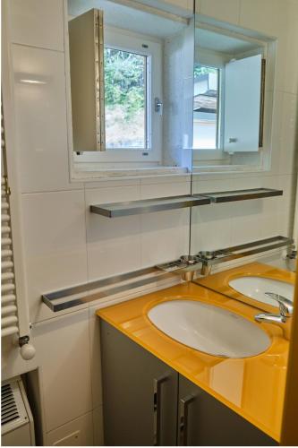a bathroom with two sinks and a mirror at Chalet di design vista Pelmo - Chalet dei Brisi in Borca di Cadore