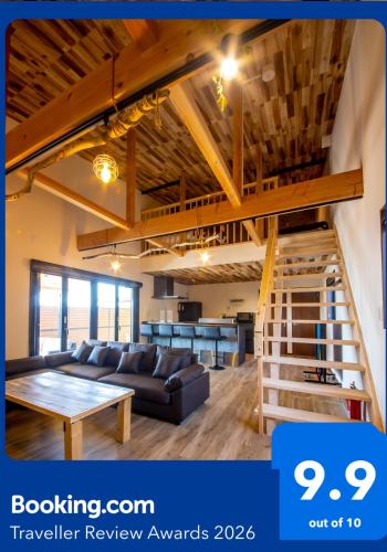 a living room with a couch and a table at 千葉地域ランキング1位獲得の贅沢な貸別荘全4棟 in Hota