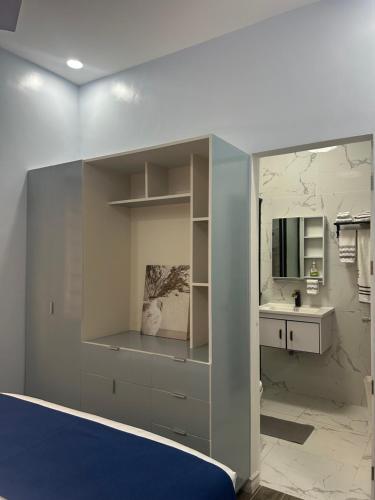a bedroom with a bed and a sink and a mirror at Casa B Pasco in Dauin