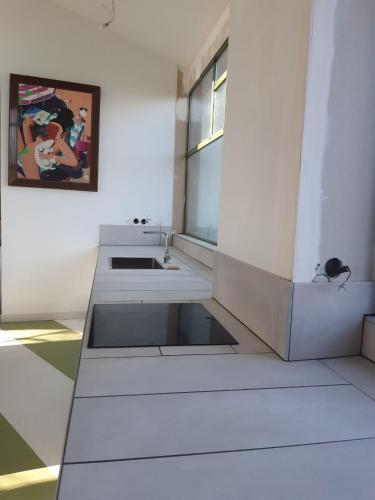 a white room with a sink and a window at Pan Demeure et Granges in Montesquieu-Avantès