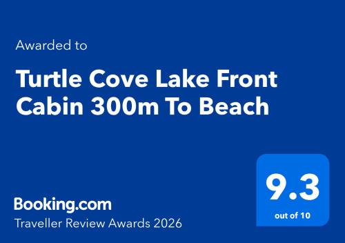 a blue sign that reads turtle cove lake front cabin to beach at Turtle Cove Lake Front Cabin 300m To Beach in Hervey Bay