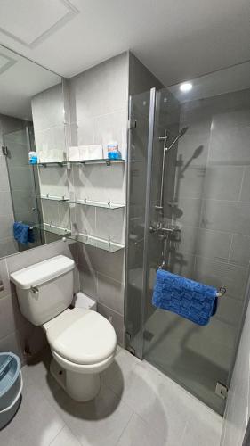a bathroom with a toilet and a glass shower at Jtower Residences Rad Staycation in SM Jmall in Mandaue City