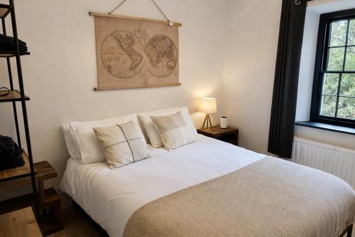 a bedroom with a bed with white sheets and pillows at Glandwr Lodge, 3 bed in Barmouth, Wales in Barmouth