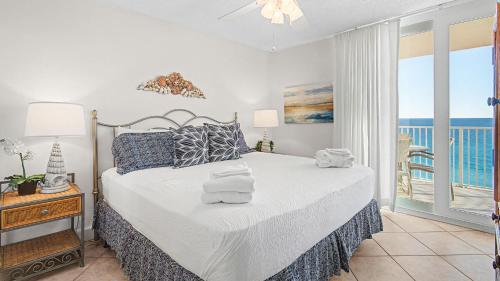 a bedroom with a bed with a view of the ocean at Beachcrest 805 in Santa Rosa Beach