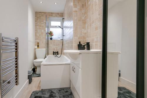 a bathroom with a sink and a toilet at Spacious 4 bed Ideal for Business & Long Term Stays, Free Parking in Manchester