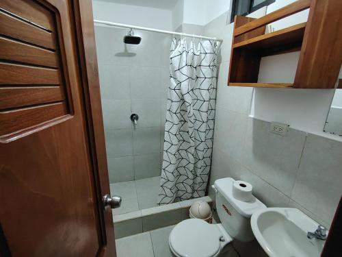 a small bathroom with a toilet and a shower at Misha Home Nro 732 in Puerto Ayora