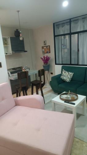 a living room with a couch and a table at Apartahotel Acuña in Moniquirá