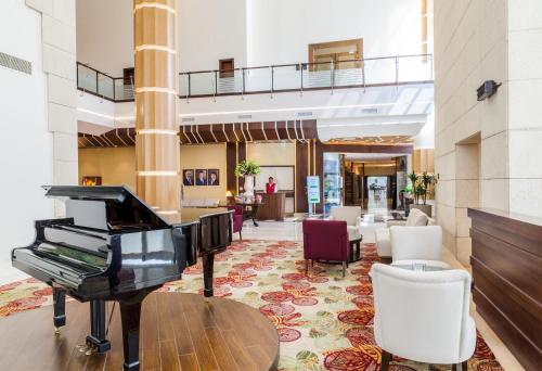 a grand piano in the lobby of a hotel at Mövenpick Hotel Amman in Amman