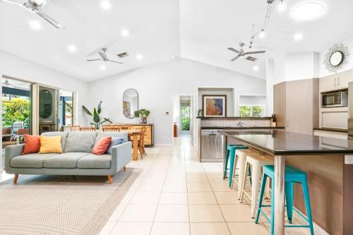 a kitchen and living room with a couch and a table at Beachfront Serenity Family Home at Wonga Beach in Wonga