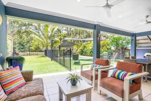 a living room with a large sliding glass door at Beachfront Serenity Family Home at Wonga Beach in Wonga