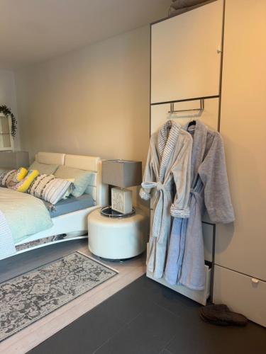 a bedroom with a bed and a mirror at One bedroom with modern kitchen, balcony with water view in Greenwich